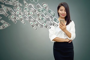 Woman watching money fly out of her cell phone